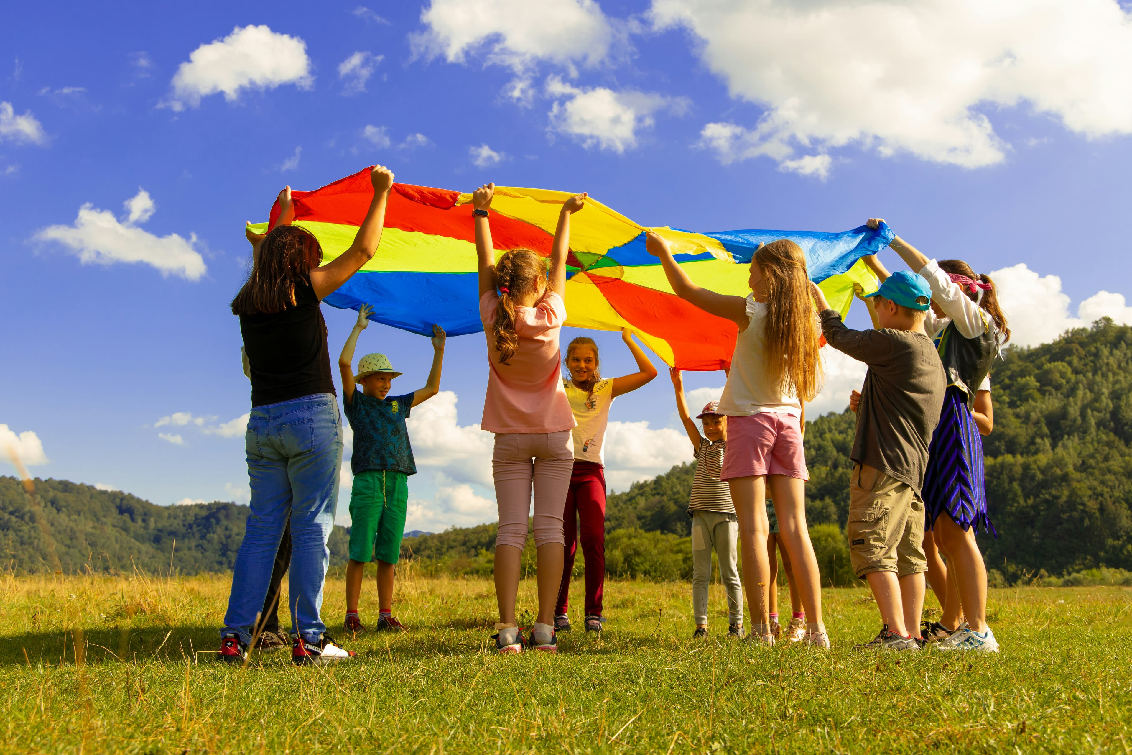 Children playing outdoors with joyful expressions in sunny resort setting