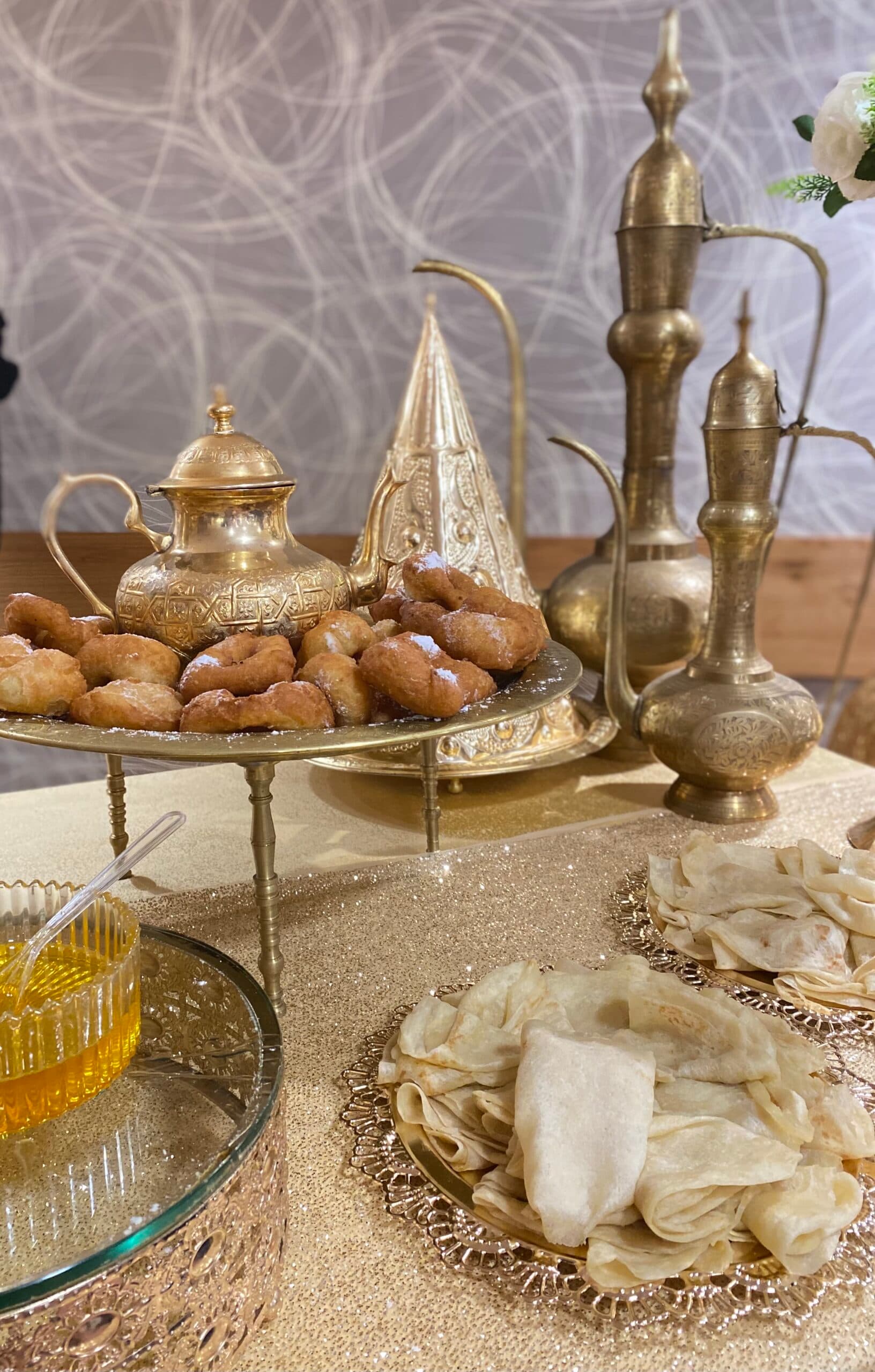 Traditional Mimouna spread with mufleta, sfenj, honey, and Moroccan brass serving pieces
